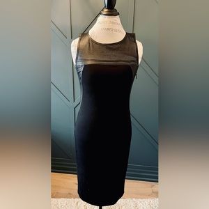 Classy with edge. Black Dress with Leather detailing at the shoulders. Size 4.